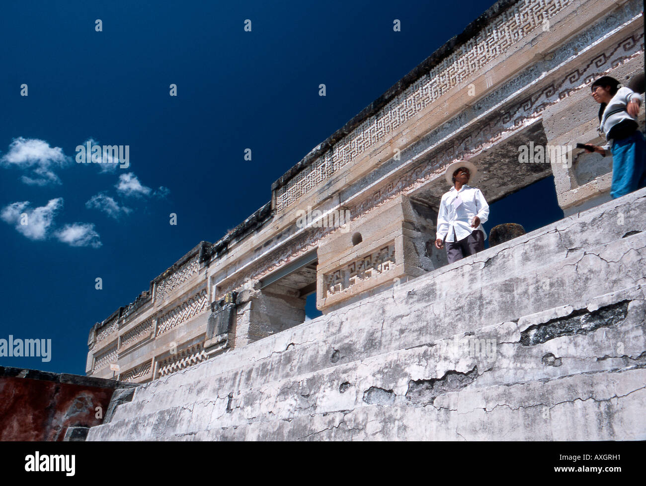 A government licensed guide explains the meaning of the architecture at the Mitla Archaeological site in Oaxaca Mexico. Stock Photo