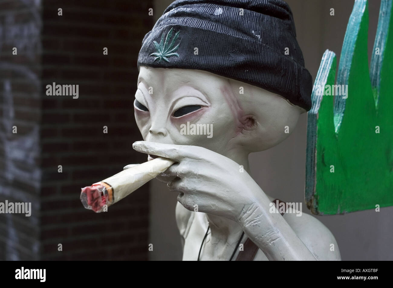 alien figure smoking cannabis joint Stock Photo