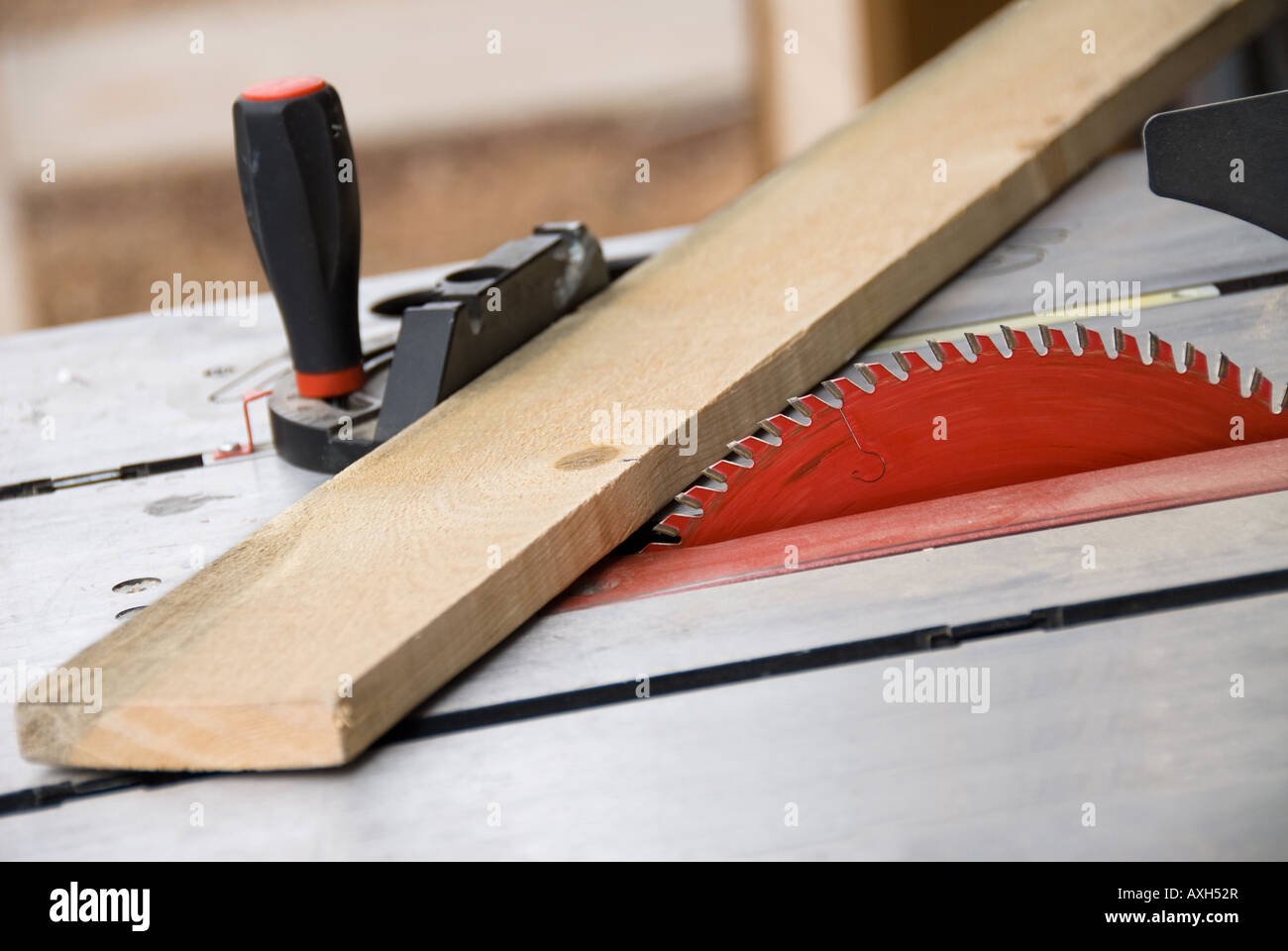 A table saw is set up to cut some 1 by 4 inch pine Stock Photo