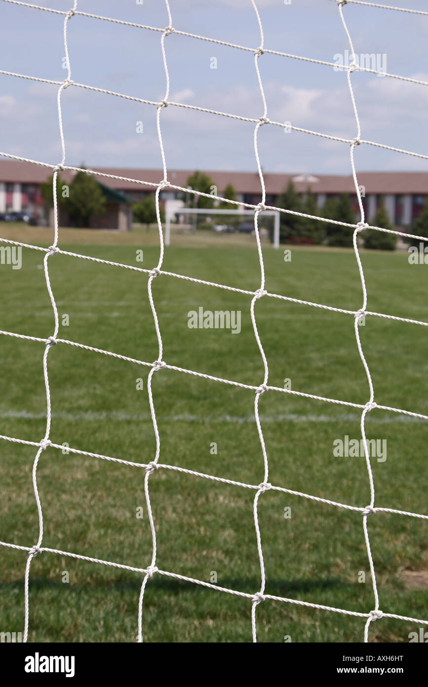 Soccer field view from behind net Stock Photo