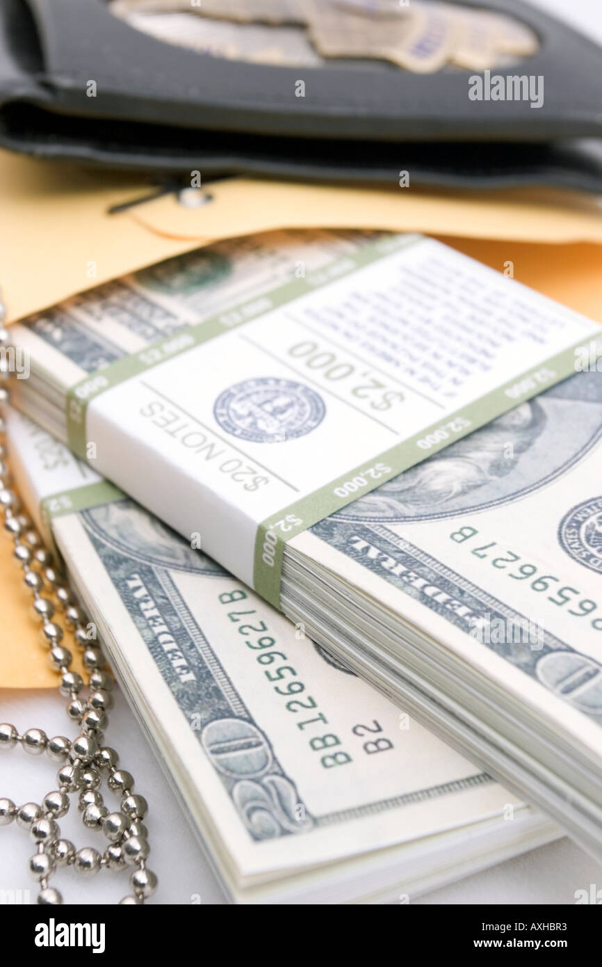 Police badge and two bundles of cash Stock Photo