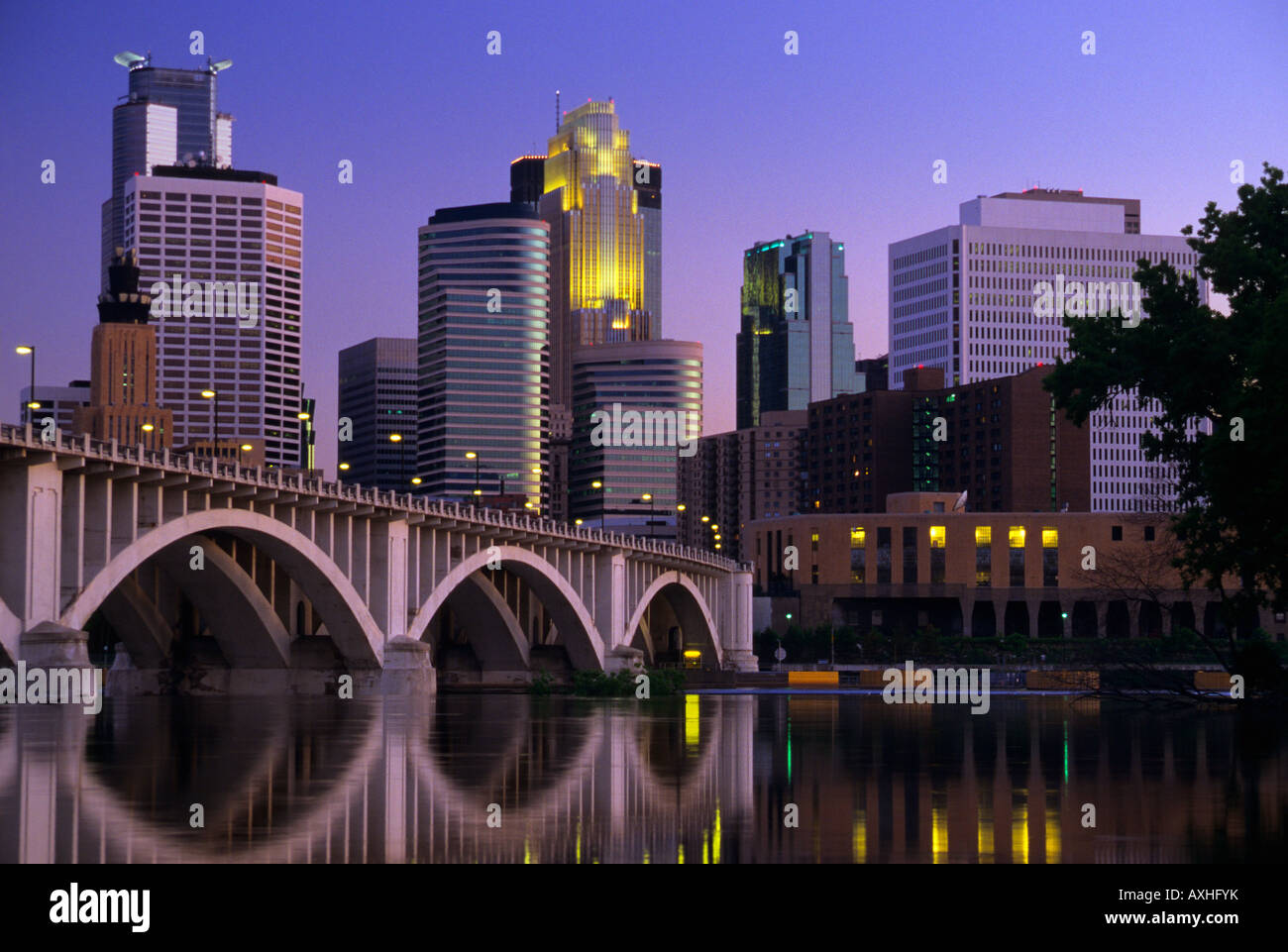 SKYLINE OF MINNEAPOLIS, MINNESOTA, THE MISSISSIPPI RIVER AND THE THIRD AVENUE-CENTRAL AVENUE BRIDGE.  DUSK; SUMMER. Stock Photo