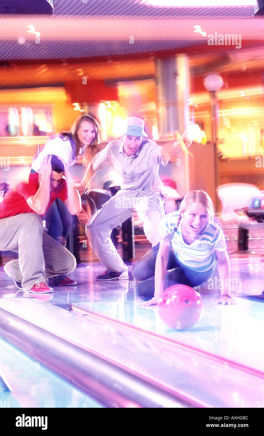 A group of young people having fun at a bowling-alley. Stock Photo