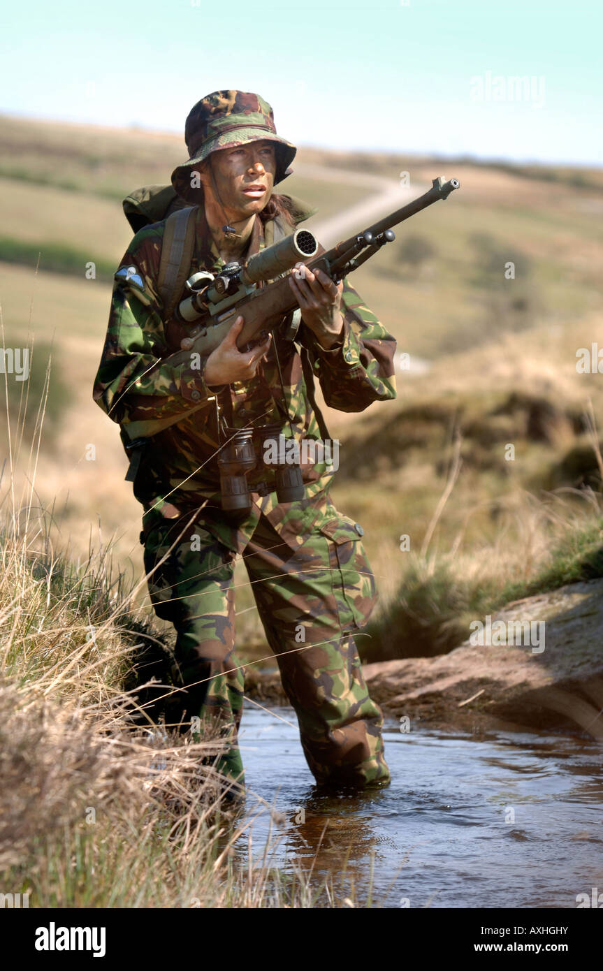 A BRITISH ARMY FEMALE ON A TRAINING STALK DURING A SNIPER COURSE IN