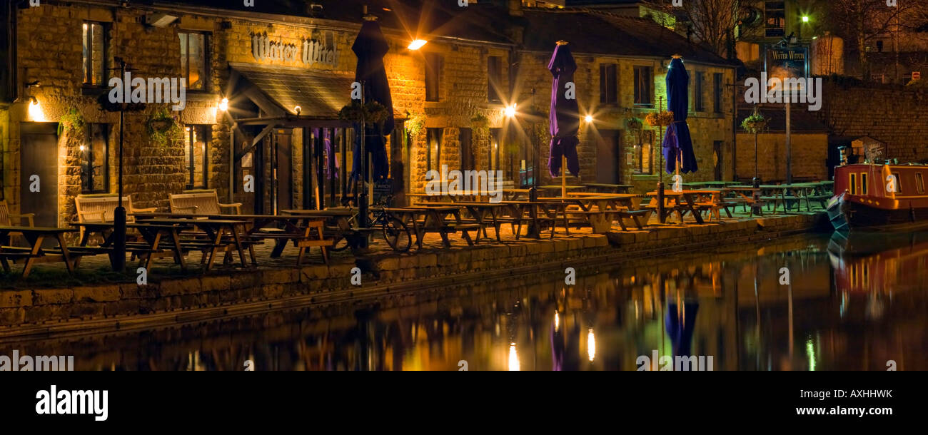 Panoramic water reflections at night by the Thwaites Water Witch Pub & Restaurant alongside the Lancaster Canal in Lancashire. Stock Photo