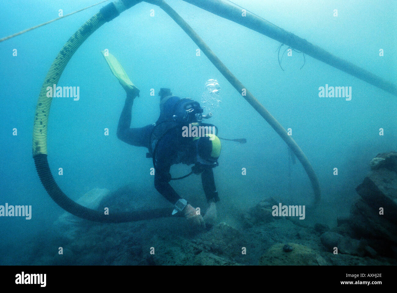 scubadiver carrying out excavations in an underwater archeological site Stock Photo