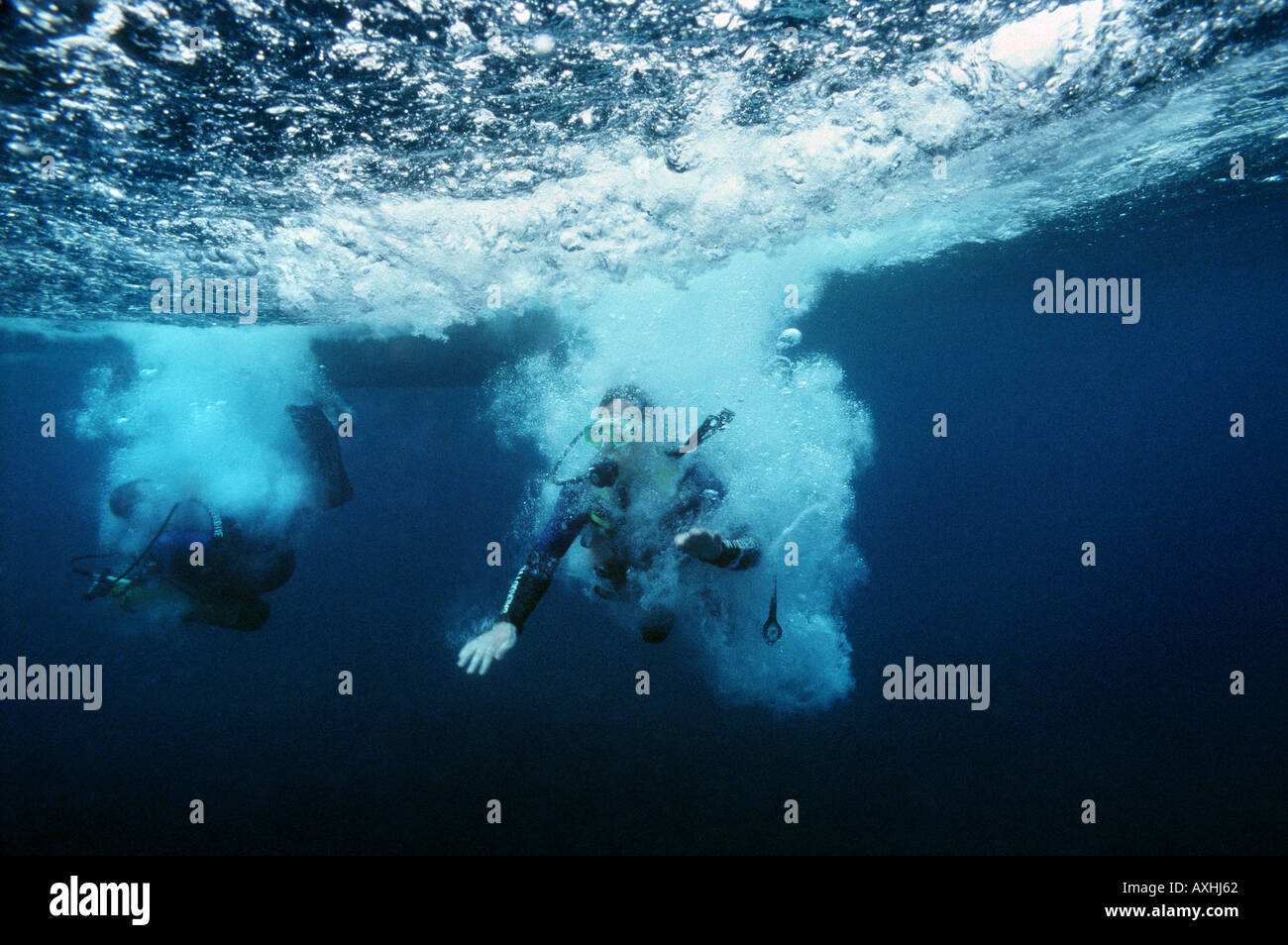 two scubadiver breaking surface Stock Photo