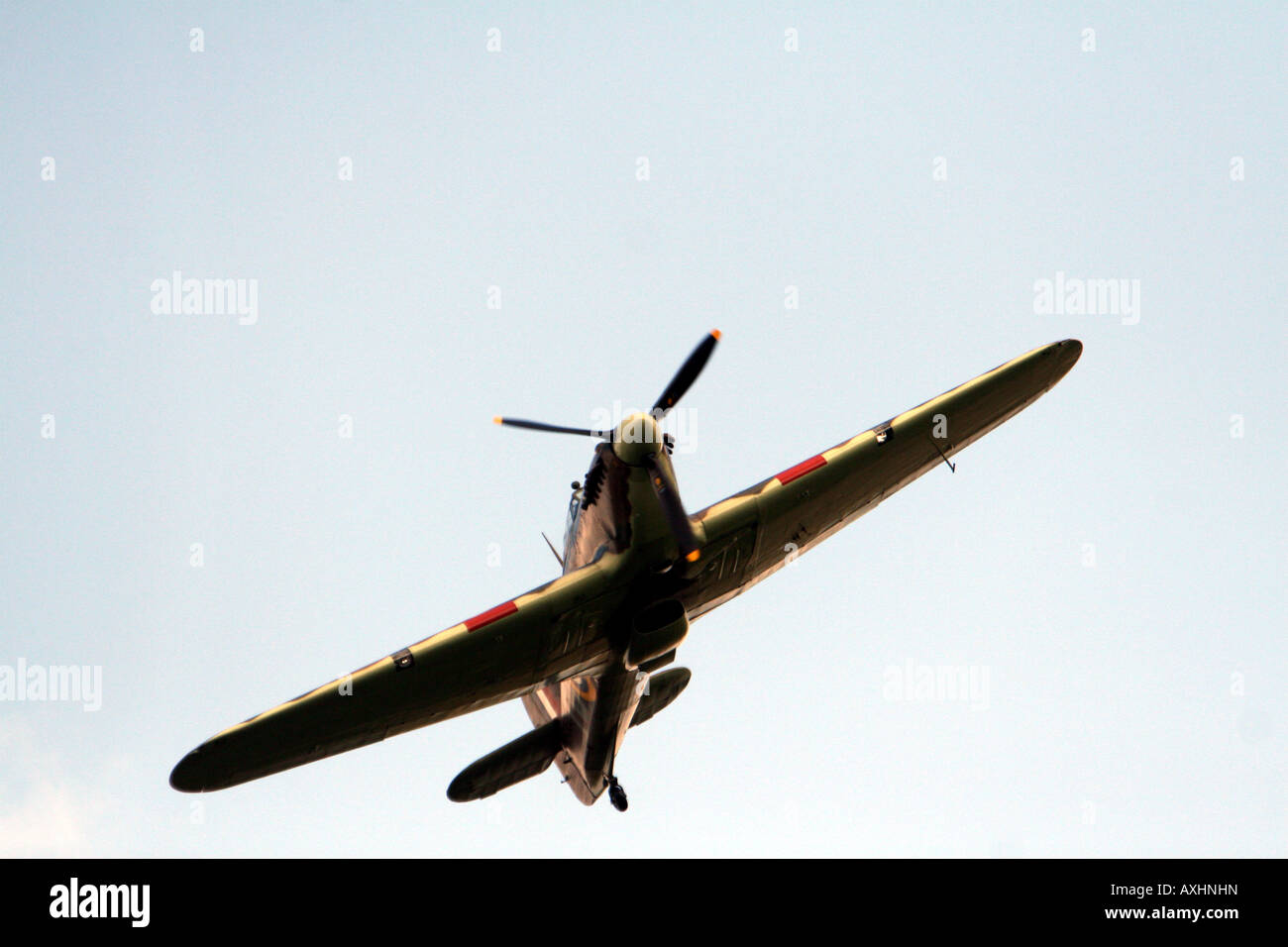 spitfire high in the sky in silohette flying bombing run Stock Photo