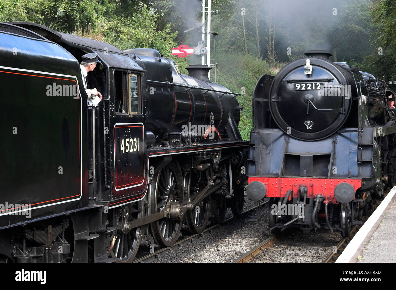 Steam power - Black 5 and 9F cross at Medstead station, Mid-Hants Railway, near Winchester, Hampshire, England. Stock Photo