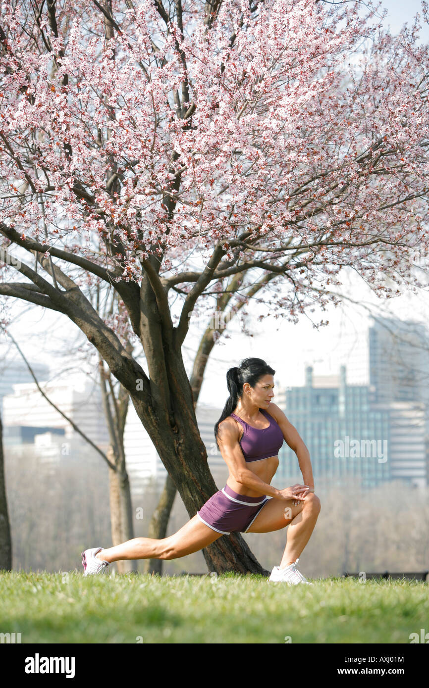 Woman athletic age 45 stretching outdoors, Cherry blossoms, Georgetown, Washington, District of Columbia, USA, MR-3-26-08-1 Stock Photo