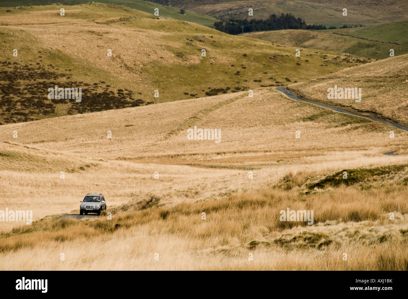 Car driving on a remote unclassified minor rural upland road through