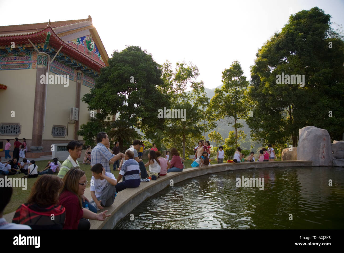 Fish pond and relaxing visitors and tourists at Kek Lok Si Temple, Georgetown, Penang Hill, Malaysia. Stock Photo