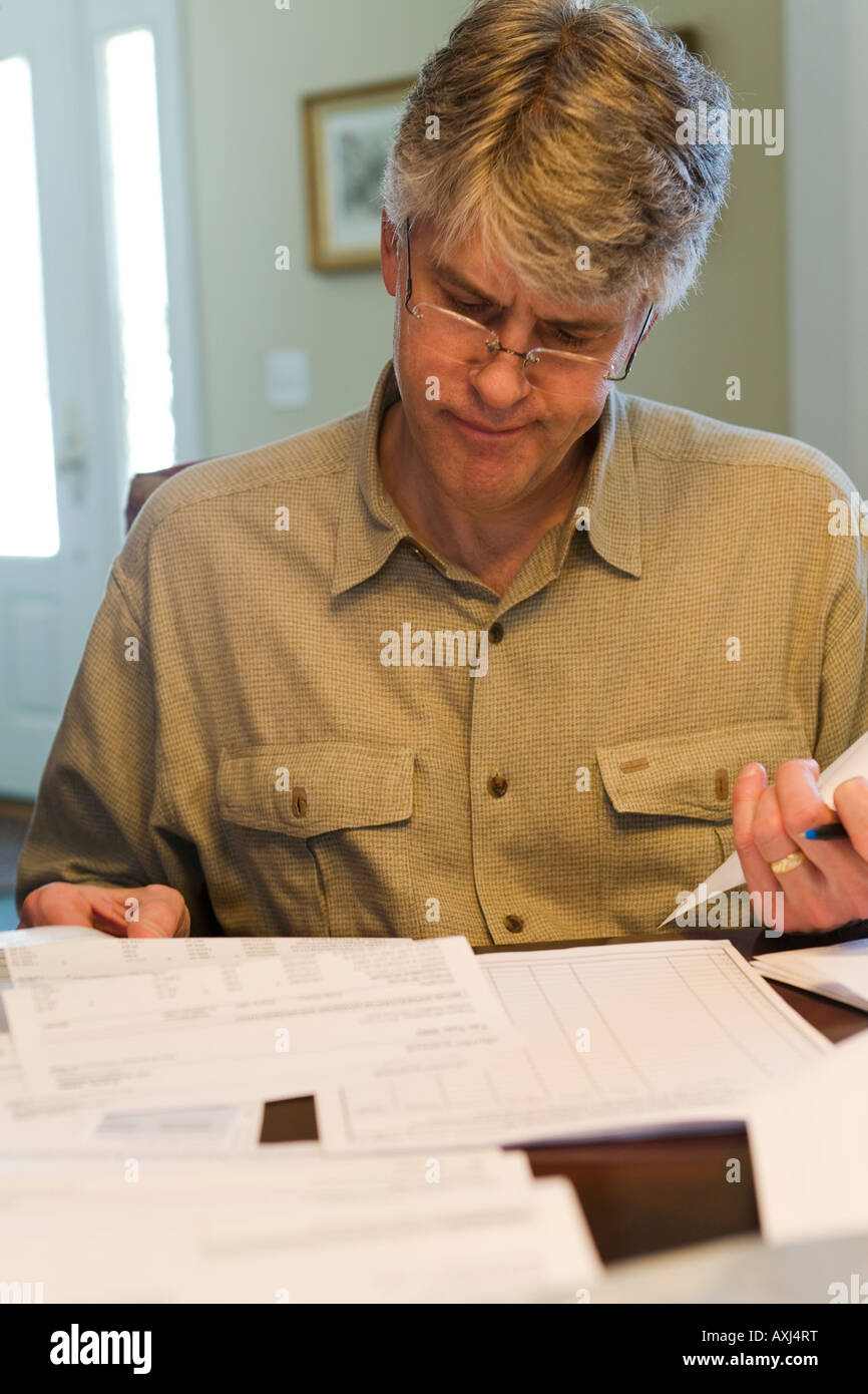 ILLINOIS Riverwoods Adult male completing forms for tax