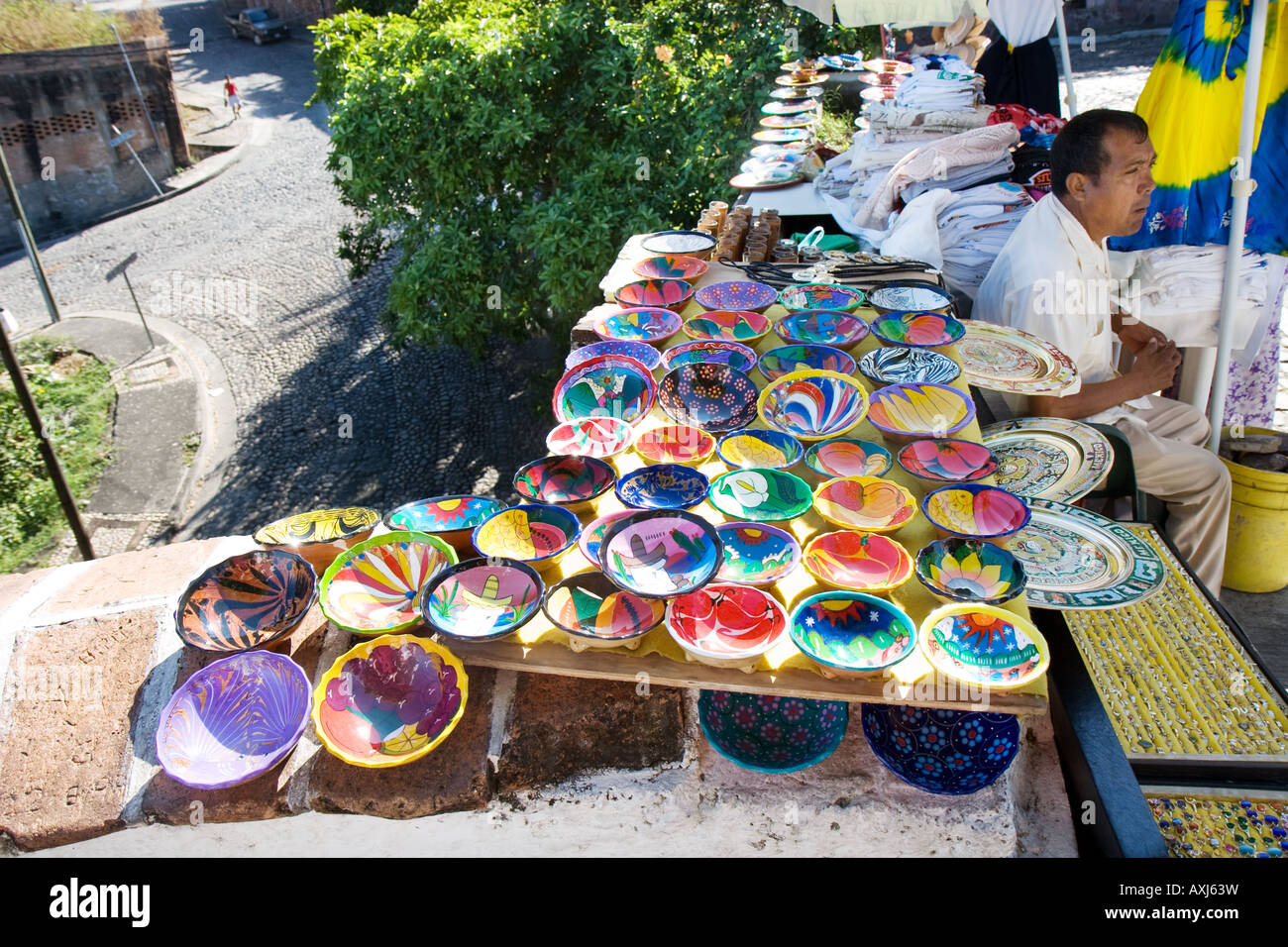 Street vendor selling handmade souvenirs on popular tourist route along