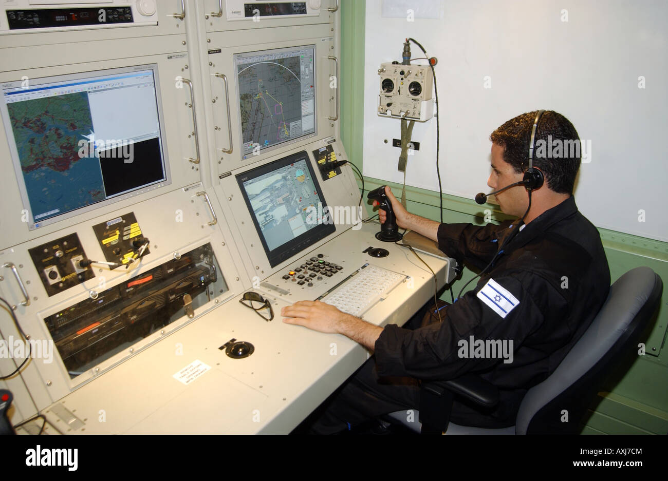 Tomer Koriat of the Israeli army monitors the data sent back by an unmanned aerial vehicle (UAV) flying over Singapore. Stock Photo