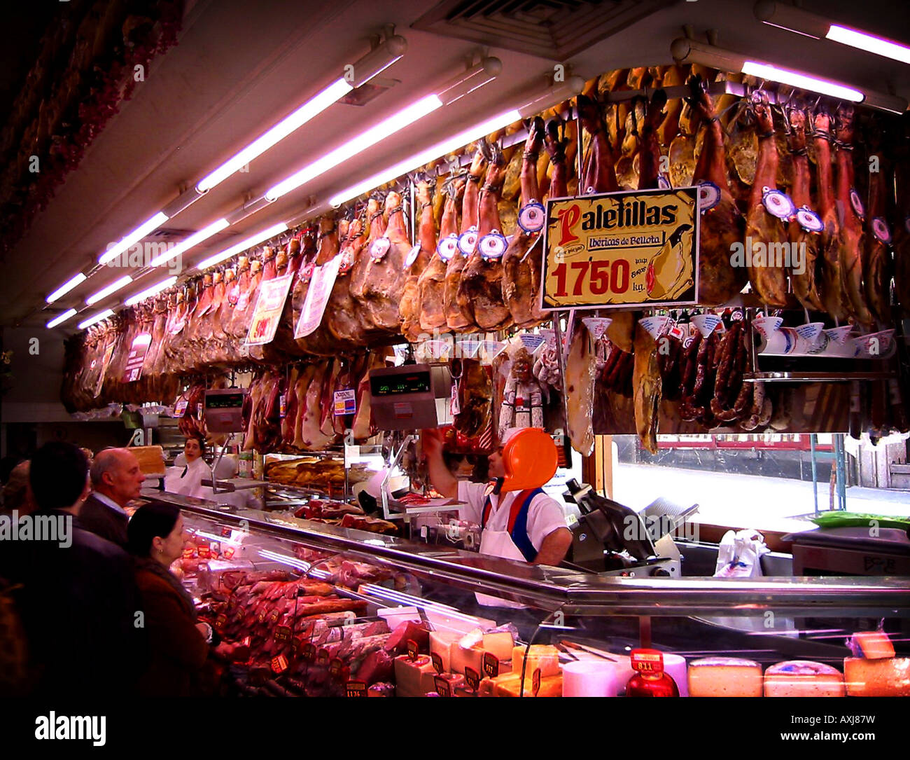 Inside of a meat market deli selling hams in Madrid, Spain Stock Photo