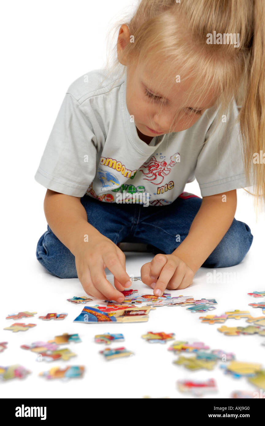 Cute little girl playing puzzles Stock Photo Alamy
