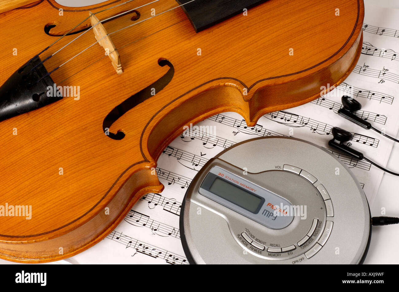 Violin and CD MP3 player New generation contemporary technologies music and musical instruments artistic conceptual still life Stock Photo