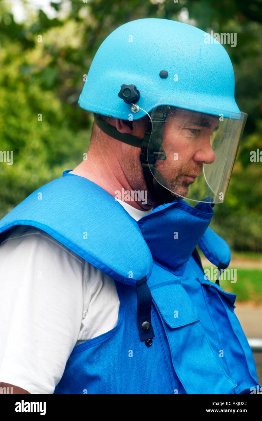 A blue helmeted mine clearance worker with armour plated chest vest. Stock Photo