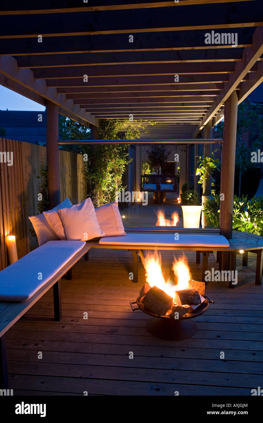 Firebowl basket on patio on outdoor seating area in garden. Stock Photo
