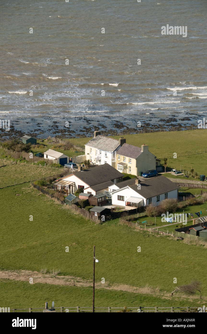 row of Houses near the sea close to the cliff edge threatened by