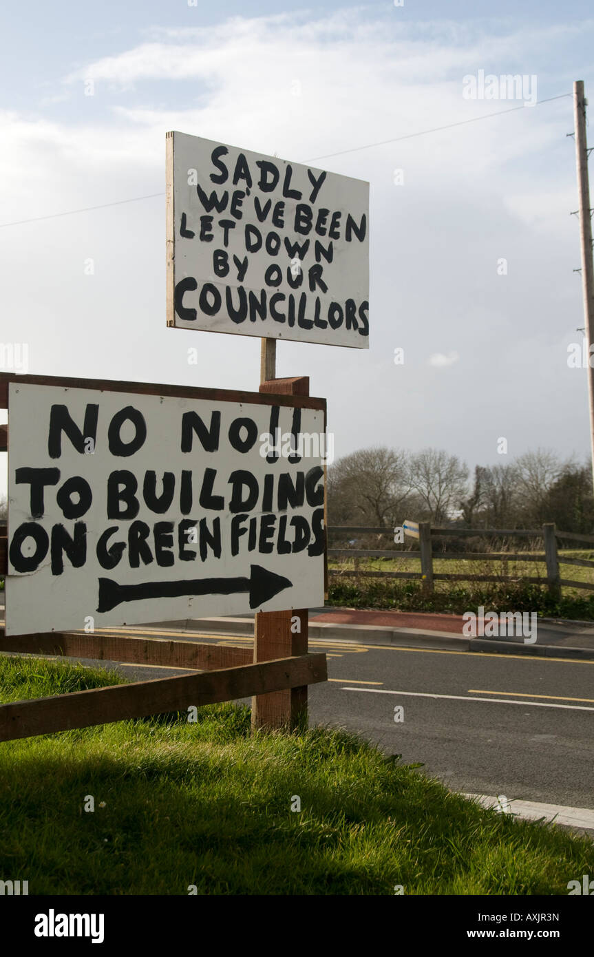 Handwritten signs put up by local residents opposing new housing development on greenfield site Llanon village west Wales UK Stock Photo