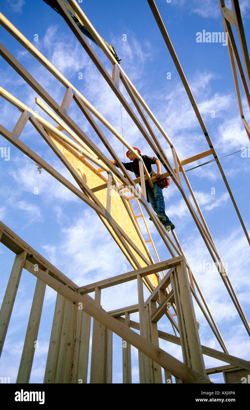 Construction worker using wood trusses for roof frame in Boise Idaho ...
