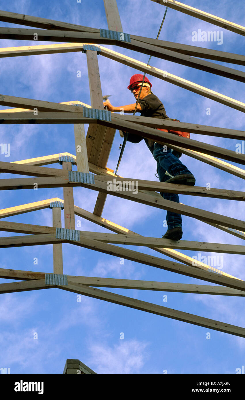 Construction worker using wood trusses for roof frame in Boise Idaho ...