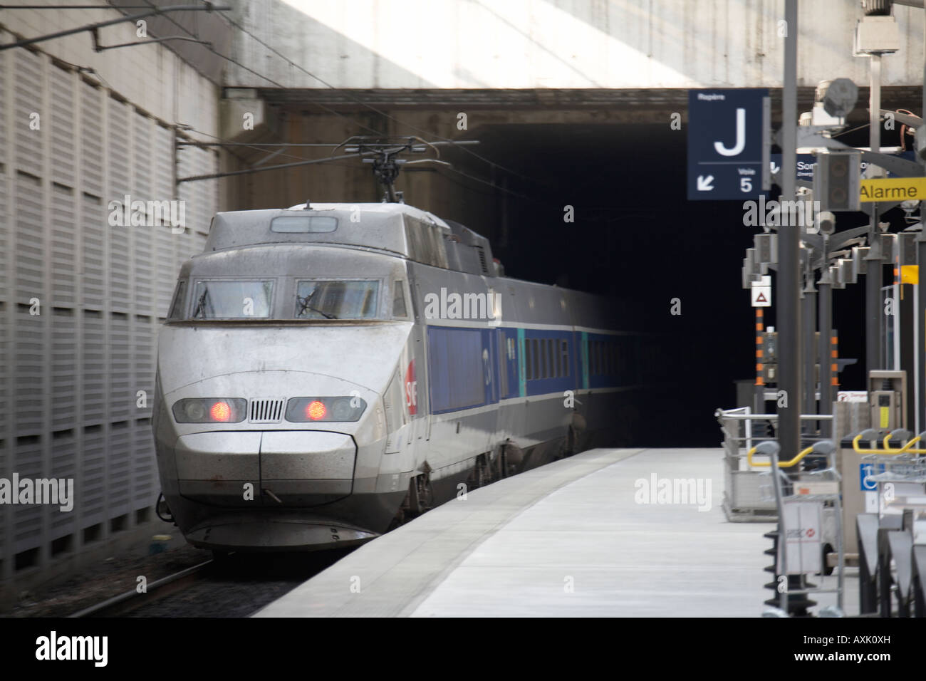 SNCF train leaving platform in TGV railway station at Charles De Gaulle International Airport or Aeroport Paris France EU Stock Photo