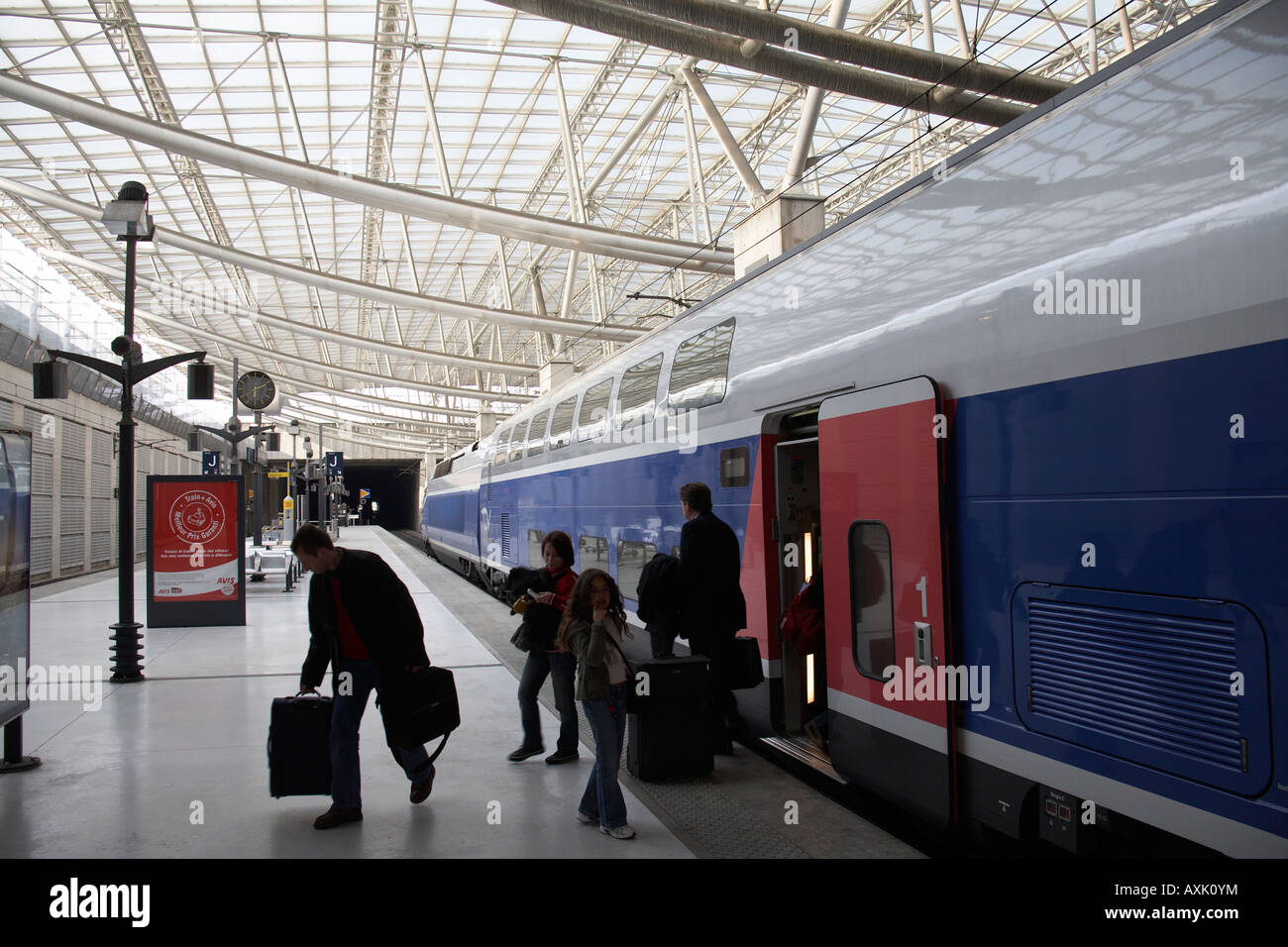 SNCF train with passengers on platform in TGV railway station at Charles De Gaulle International
