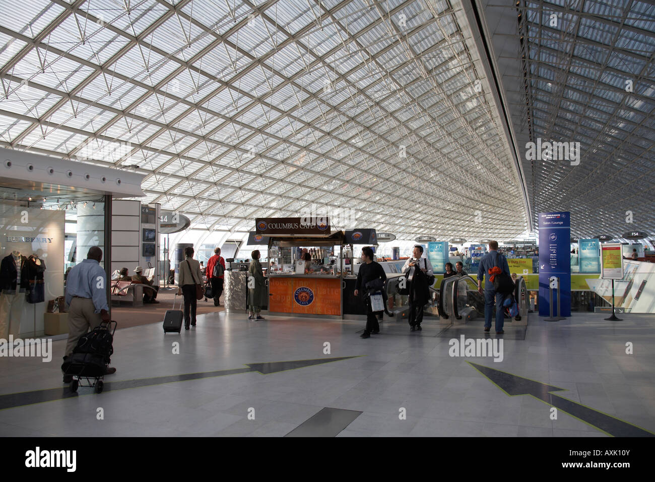 Passengers under steel and glass canopy in Terminal 2F at Charles De Gaulle  International Airport Paris France Stock Photo - Alamy