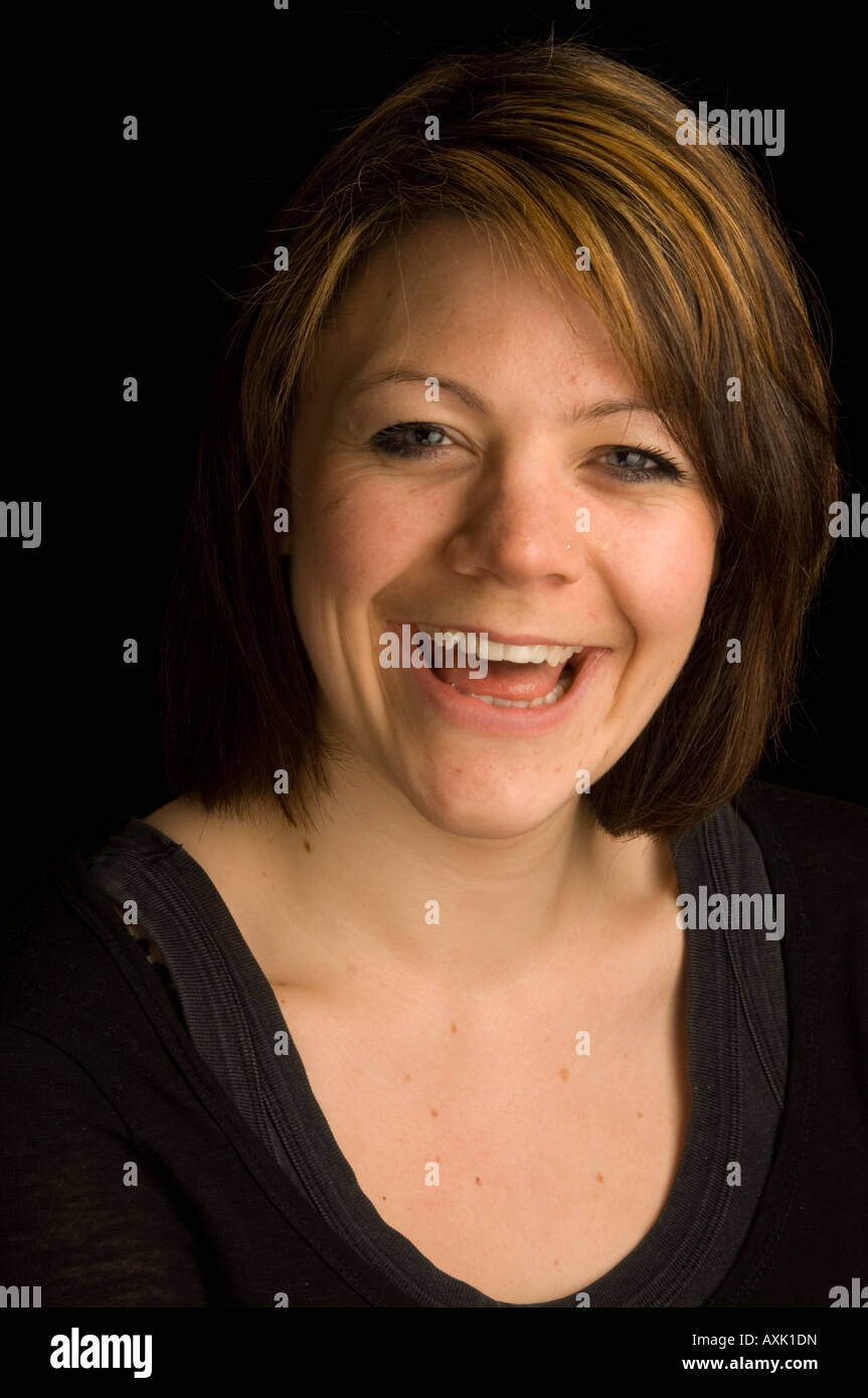 studio head and shoulders portrait of Laughing young adult caucasian ...