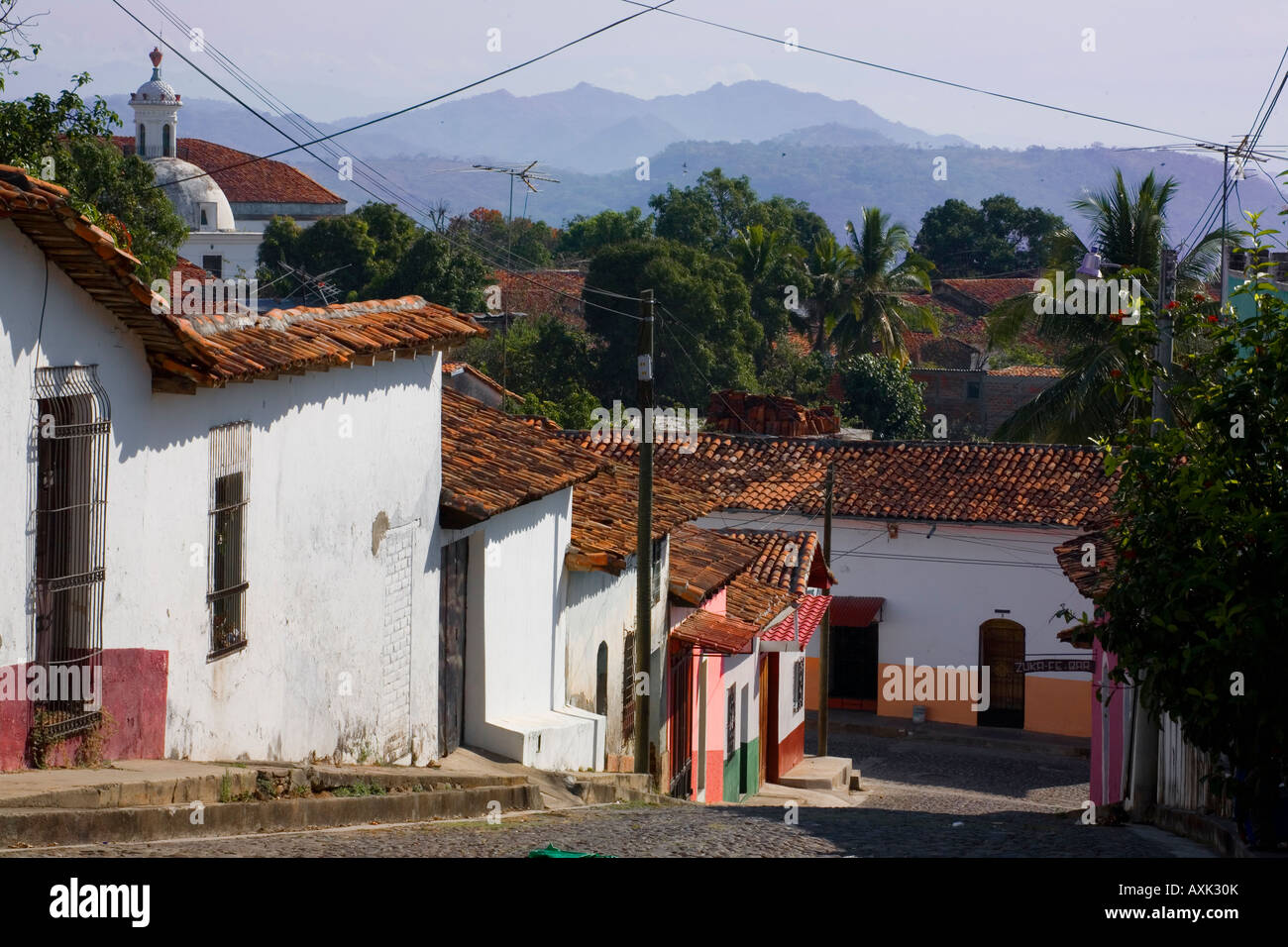 Cobblestone streets colonial adobe homes terra cotta roof Suchitoto El Salvador Stock Photo