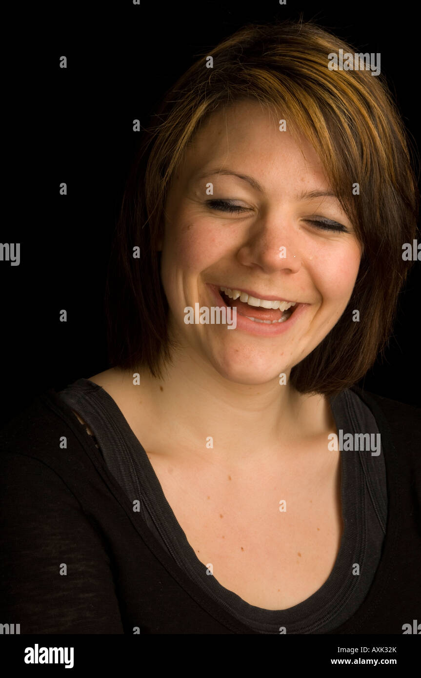head and shoulders studio portrait Laughing young caucasian woman ...