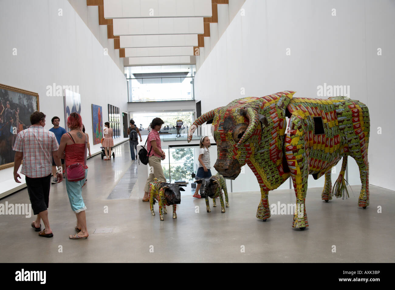 Bull sculpture on display with people in interior of Gallery of Modern Art Brisbane Queensland QLD Australia Stock Photo
