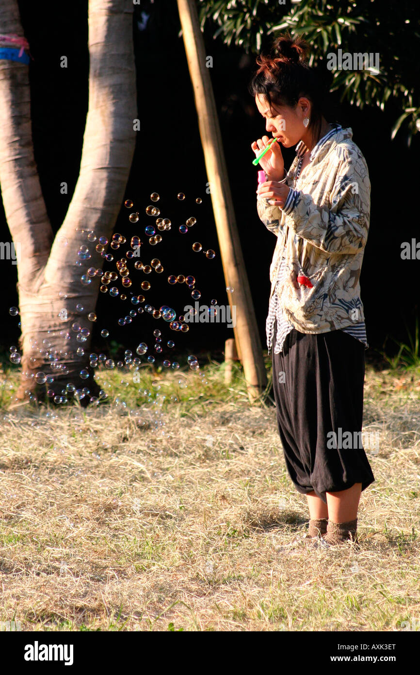 Japanese Woman blowing bubbles in Yoyogi Park (Yoyogi-Koen), Tokyo, Japan Stock Photo