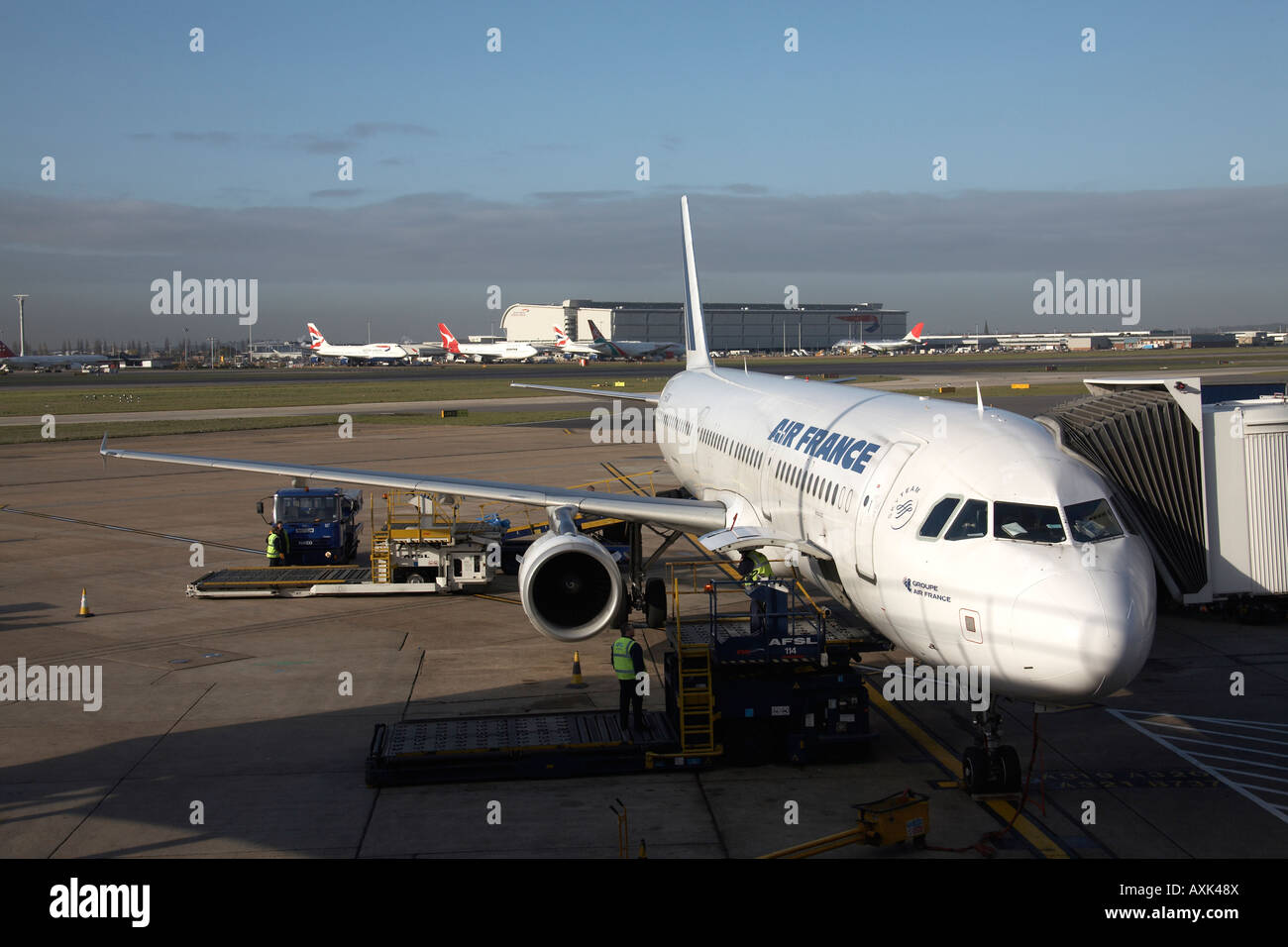 Airbus aircraft being loaded up pre flight airside at Heathrow airport London England UK Stock Photo