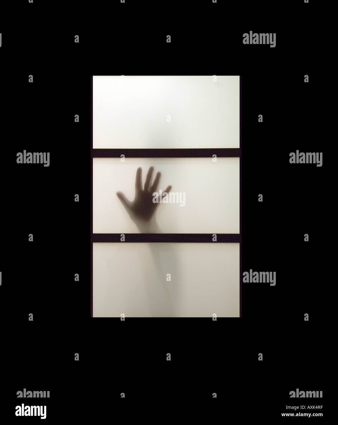 Hand Backlit Backlit photo of a hand behind a frosted glass window with a black ...