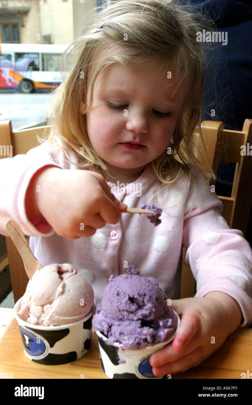 Girl eating icecream in an icecream parlour Stock Photo Alamy