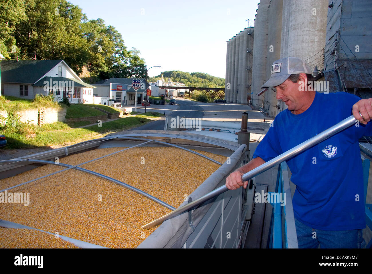 Worker sampling corn for moisture content at a grain elevator in
