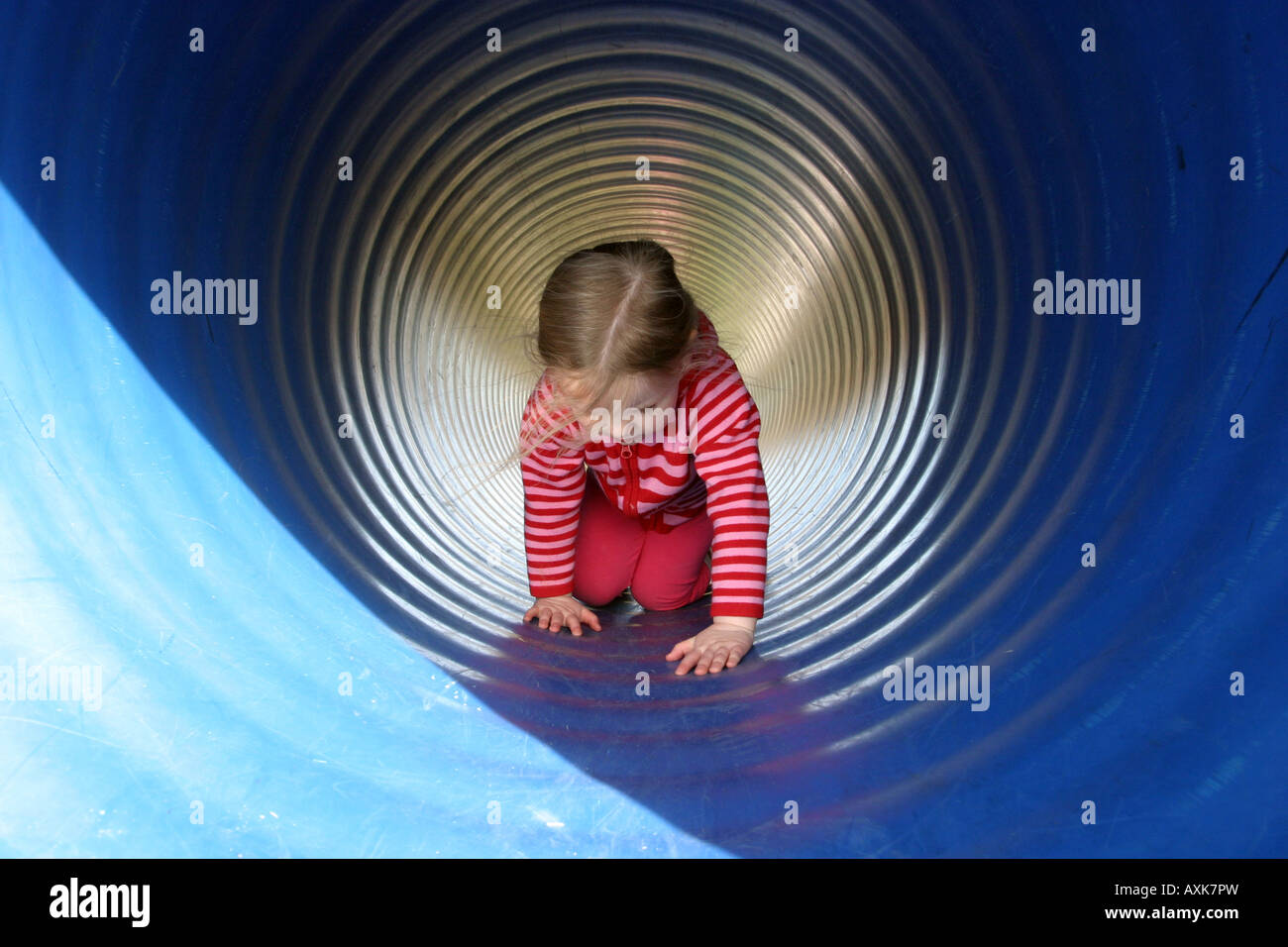 Girl crawling through tunnel Stock Photo Alamy