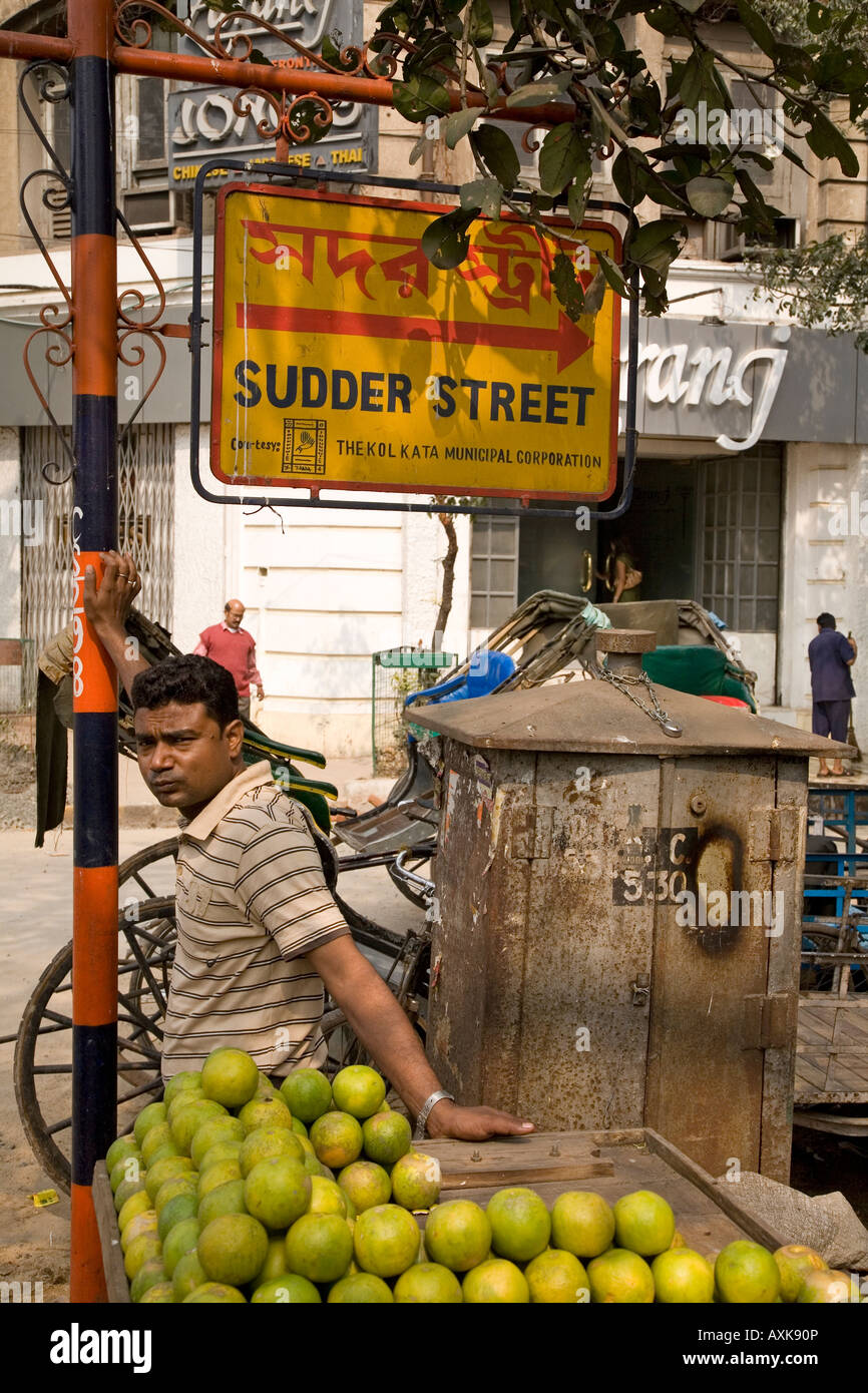 A fruit seller stands on the corner of Chowringhee Road and Sudder Street. Stock Photo