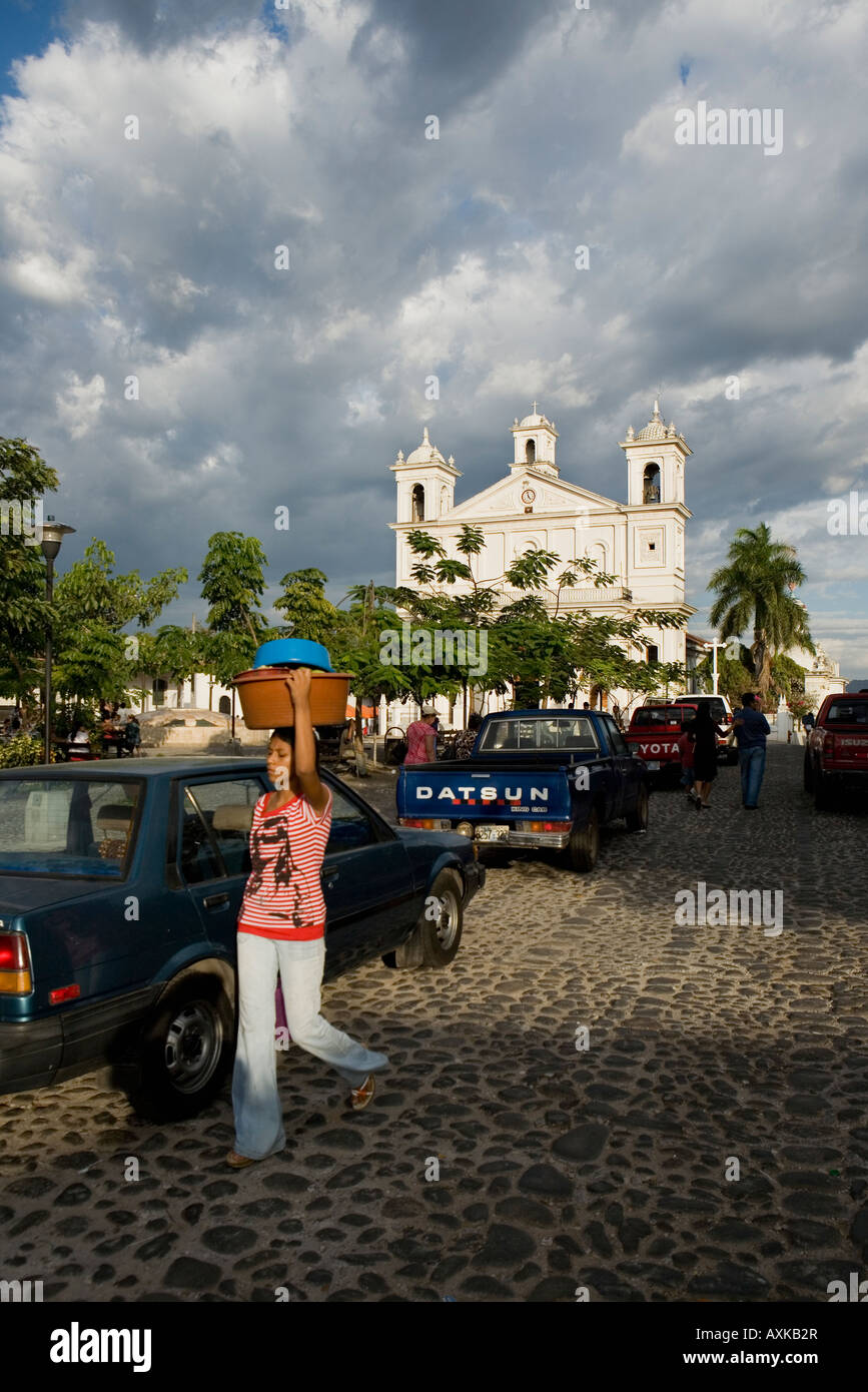 Catholic Church on Parque Centenario village square cobblestone woman carrying Suchitoto El Salvador Stock Photo