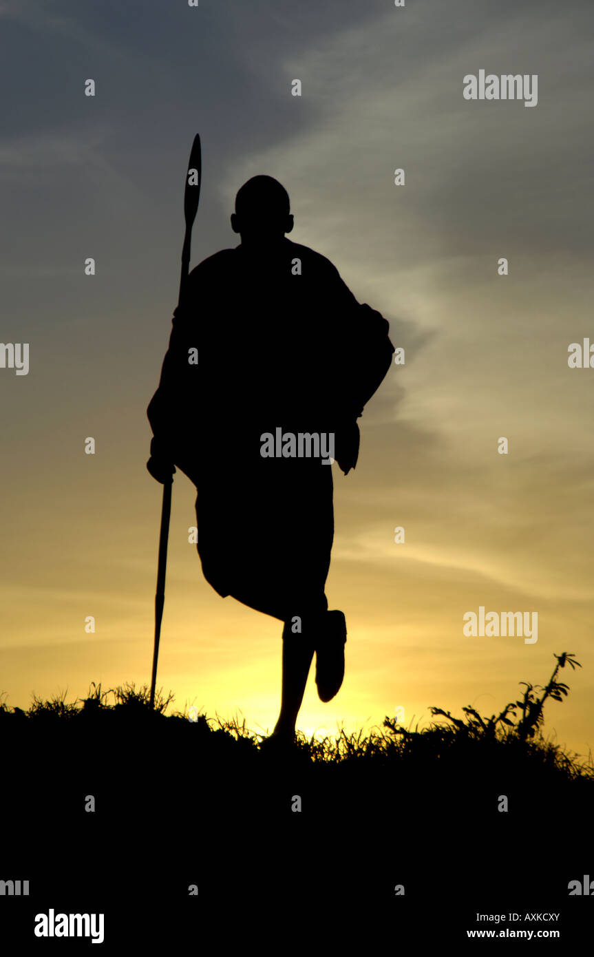 Silhouette of Masaii warrior at Sunrise Masaii Mara Kenya Stock Photo