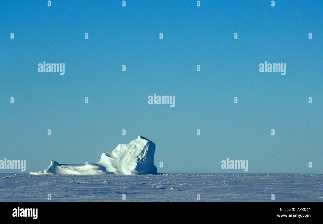Iceberg frozen in sea ice, Canada Stock Photo