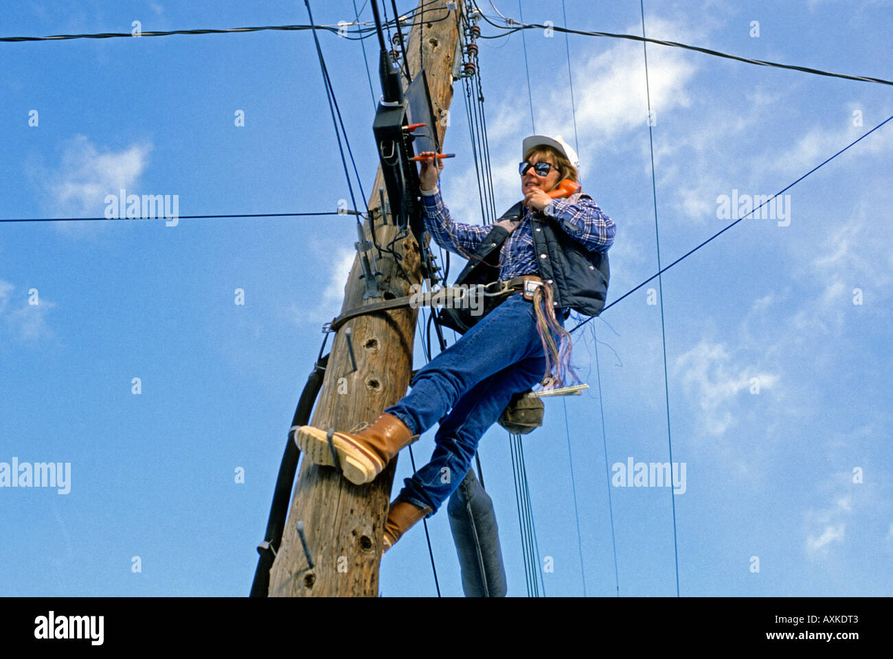 Female telephone lineman making repairs Stock Photo Alamy