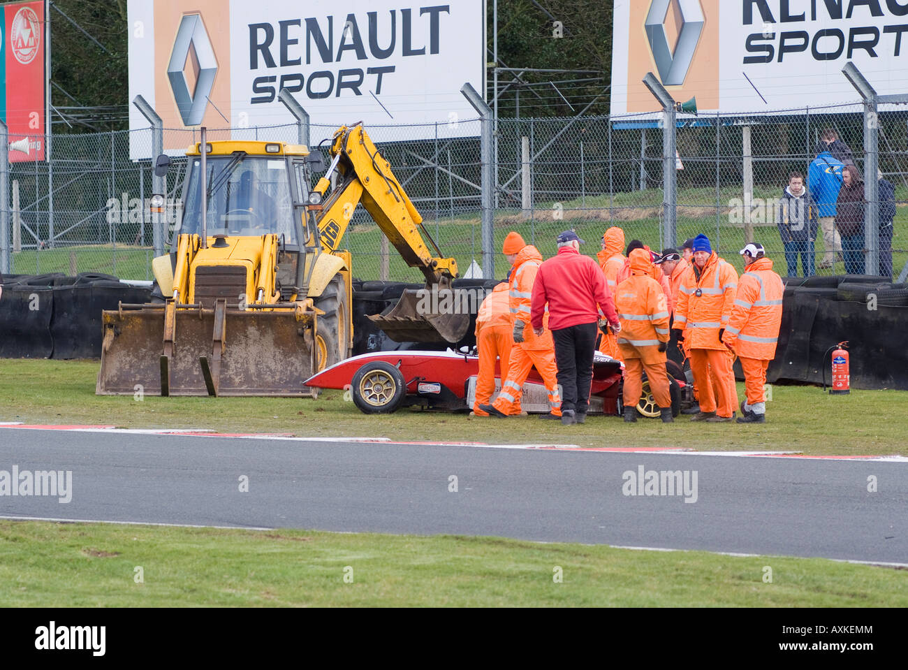 Team of Track Marshalls Recovering F3 Dallara F306 Following Accident at Oulton Park Motor Race Track Cheshire England UK Stock Photo
