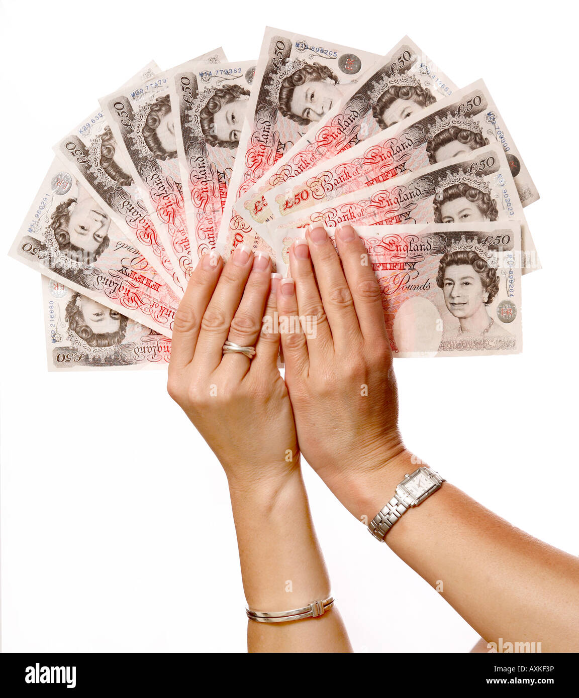 Woman's hands holding £50 notes fanned out Stock Photo