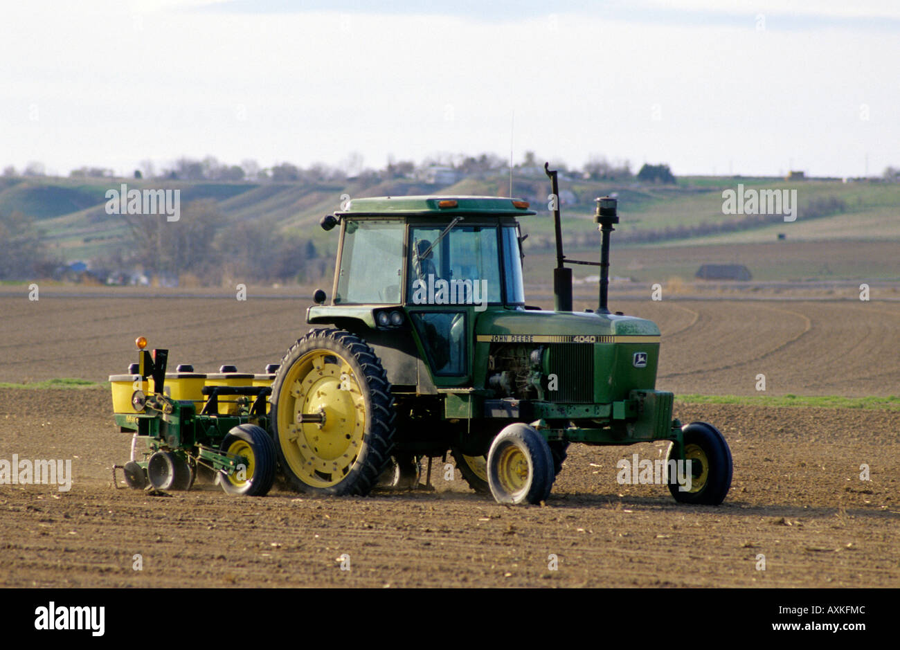 A tractor being used for spring planting and seeding in Canyon County Idaho Stock Photo