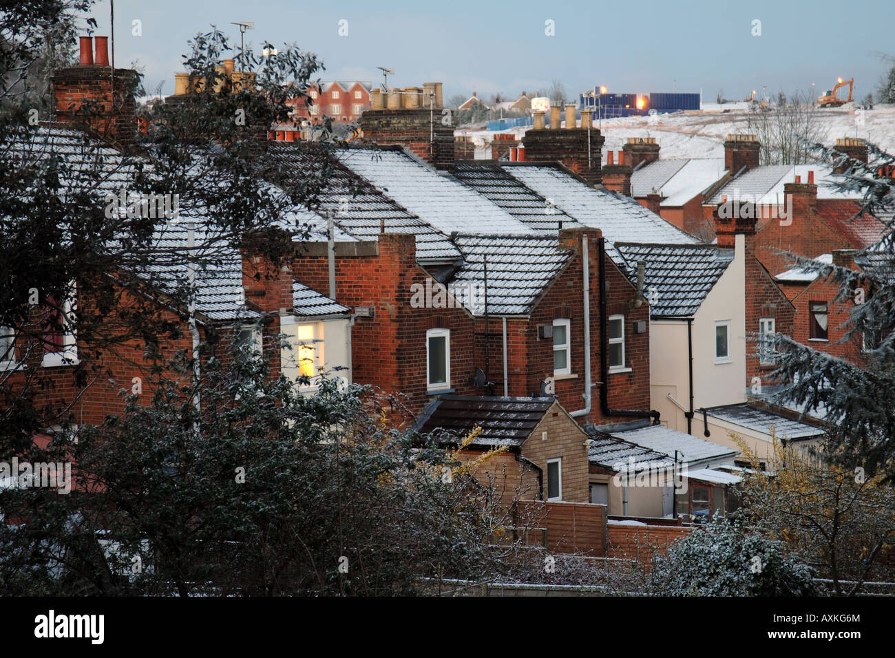 Backs of City Terraced houses at dusk in Winter Snow Stock Photo